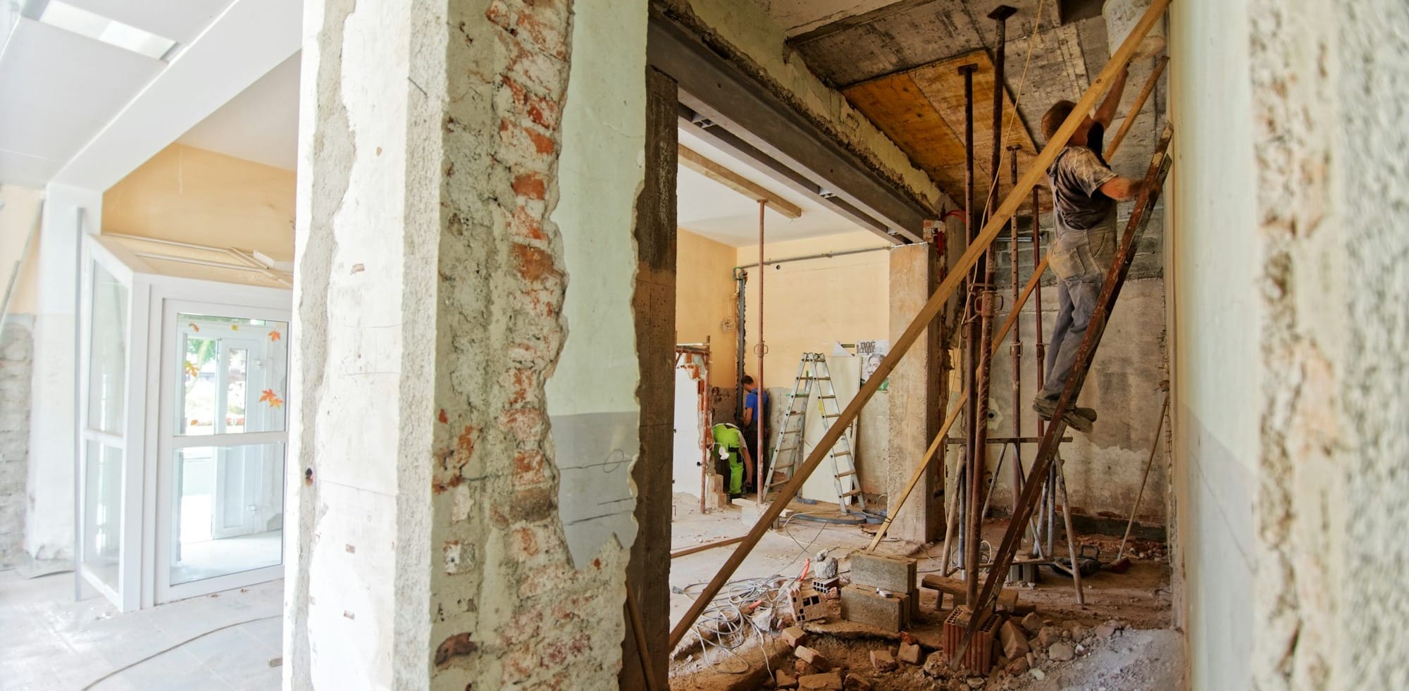 man climbing on ladder inside room