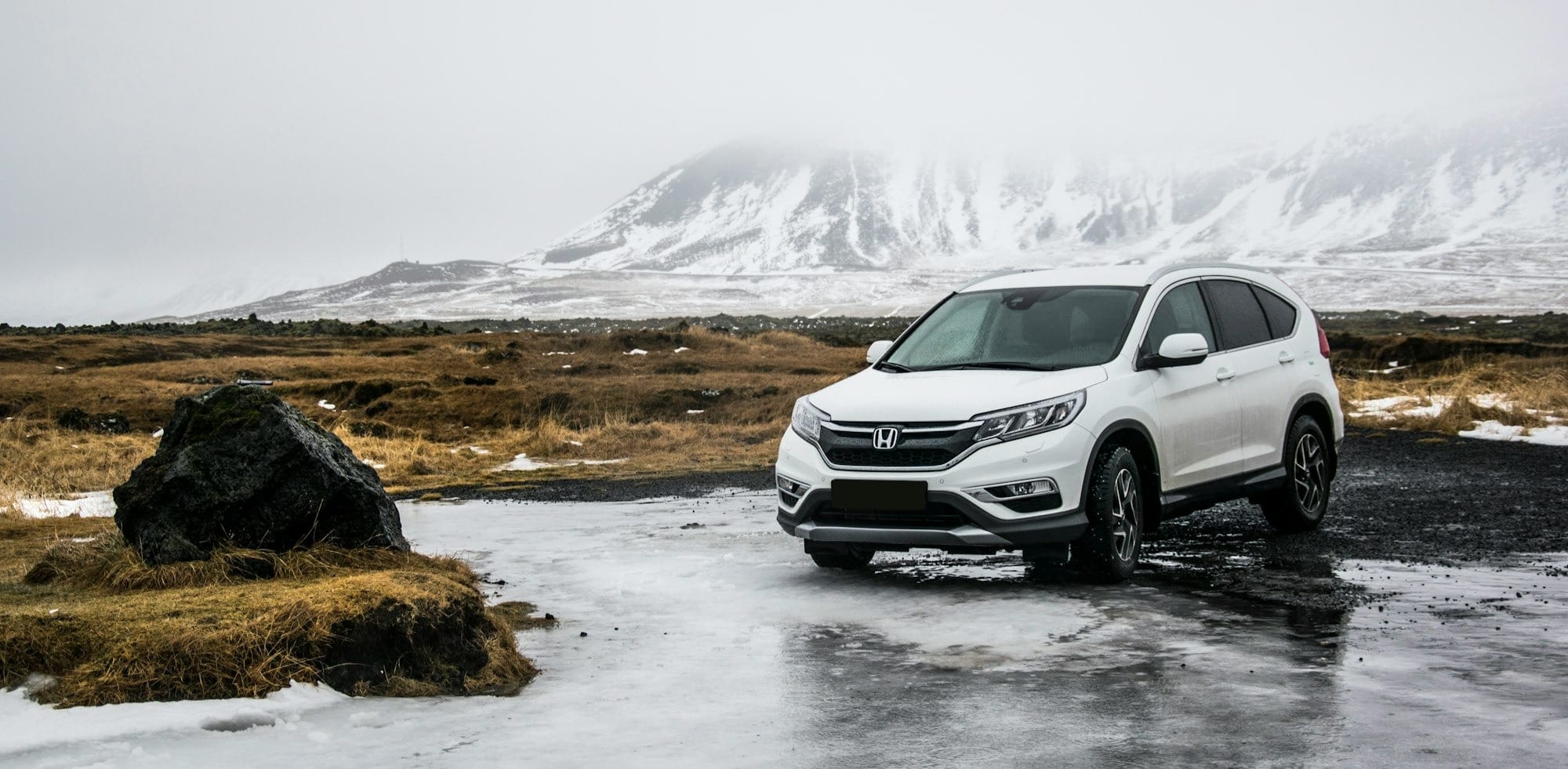 white Honda SUV on gray floor