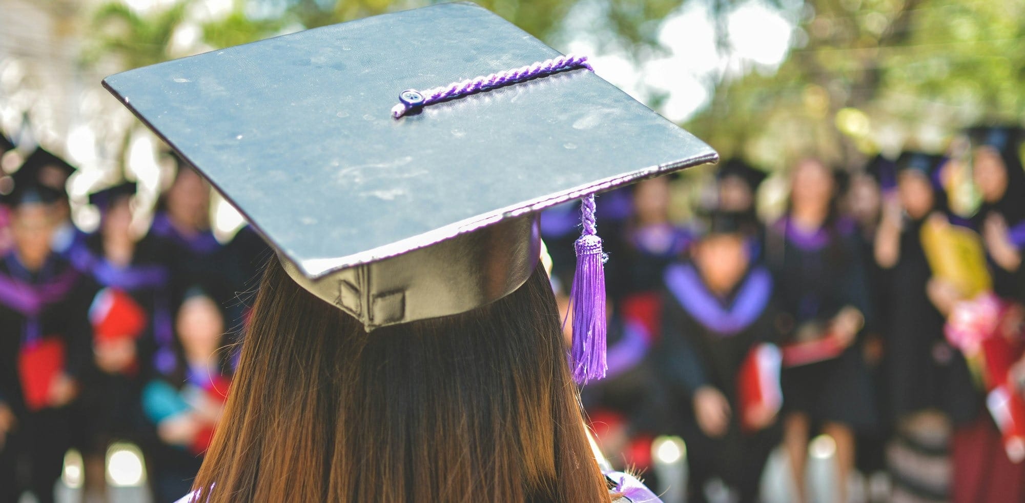 woman wearing academic cap and dress selective focus photography