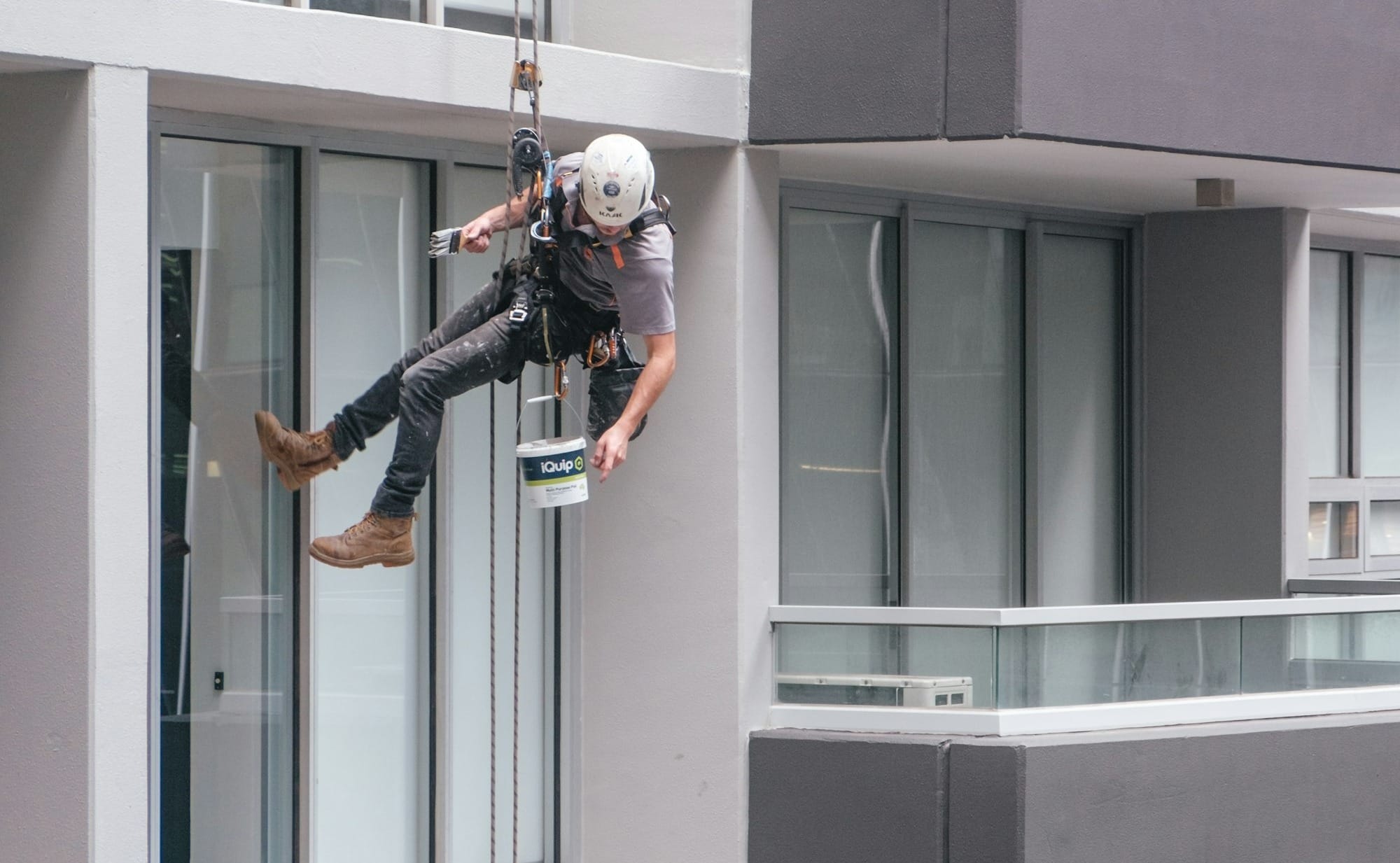 man in black jacket and black pants jumping on window during daytime