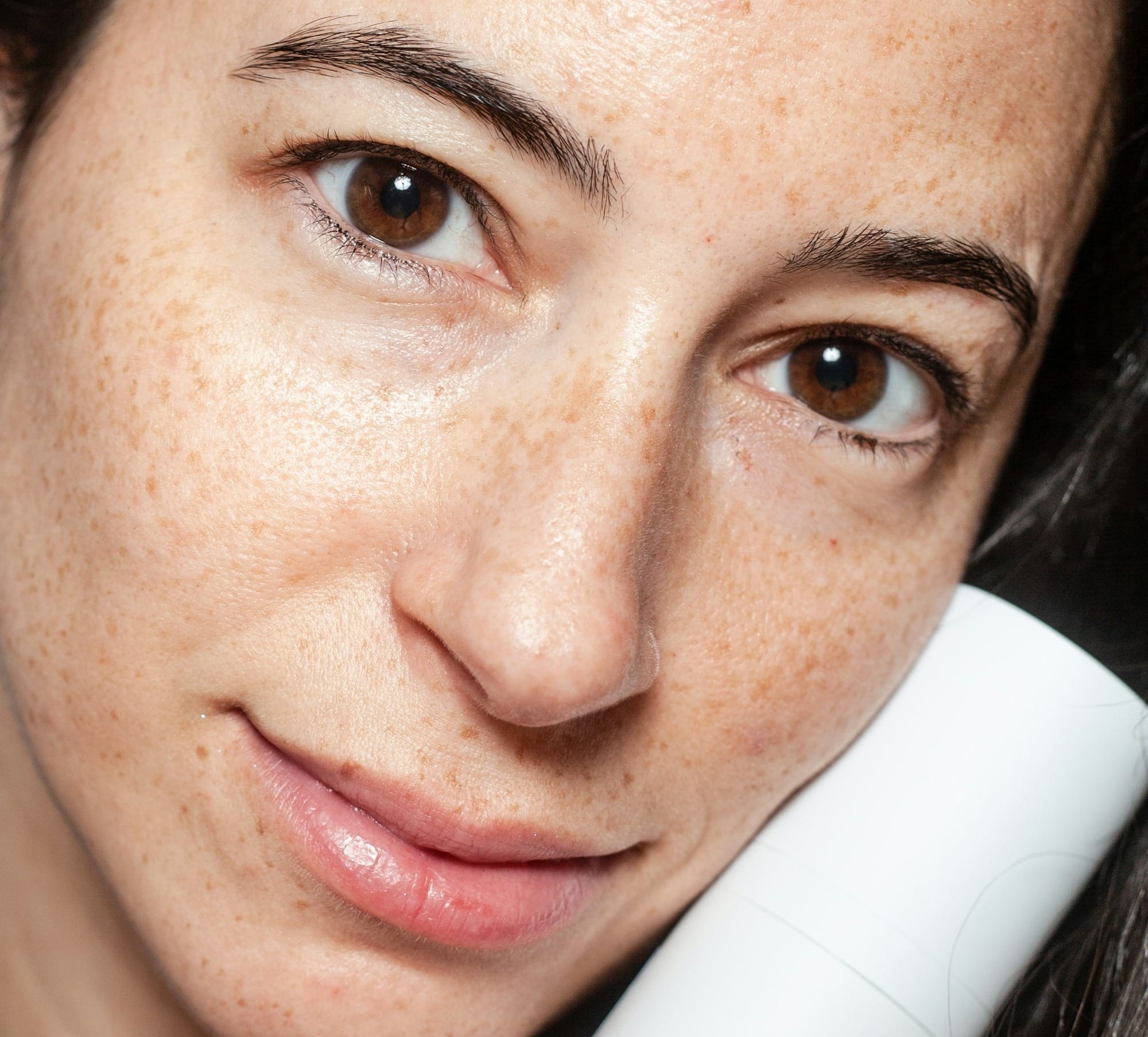 woman holding Curology bottle