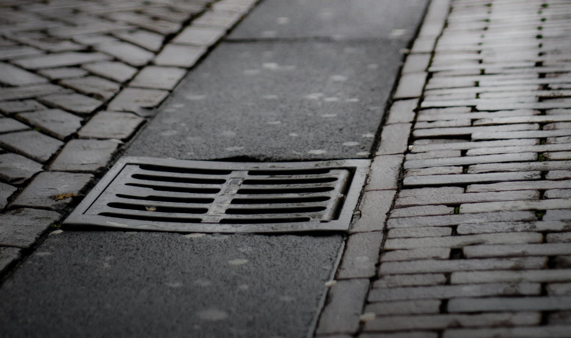 a brick sidewalk with people walking on it