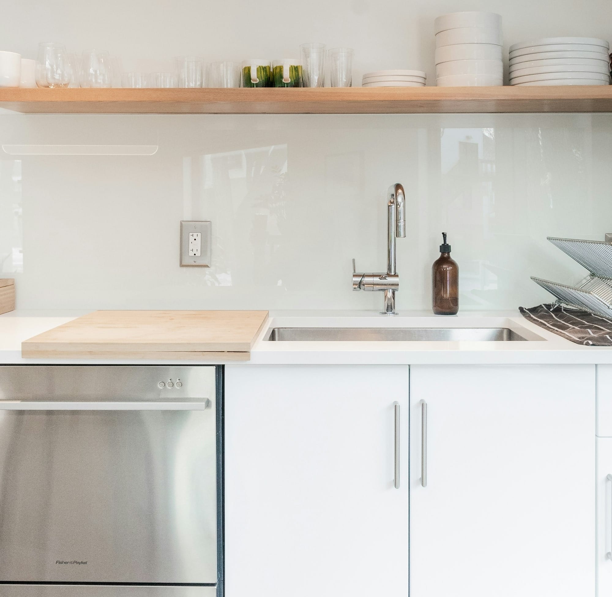 white ceramic plates on white wooden kitchen cabinet