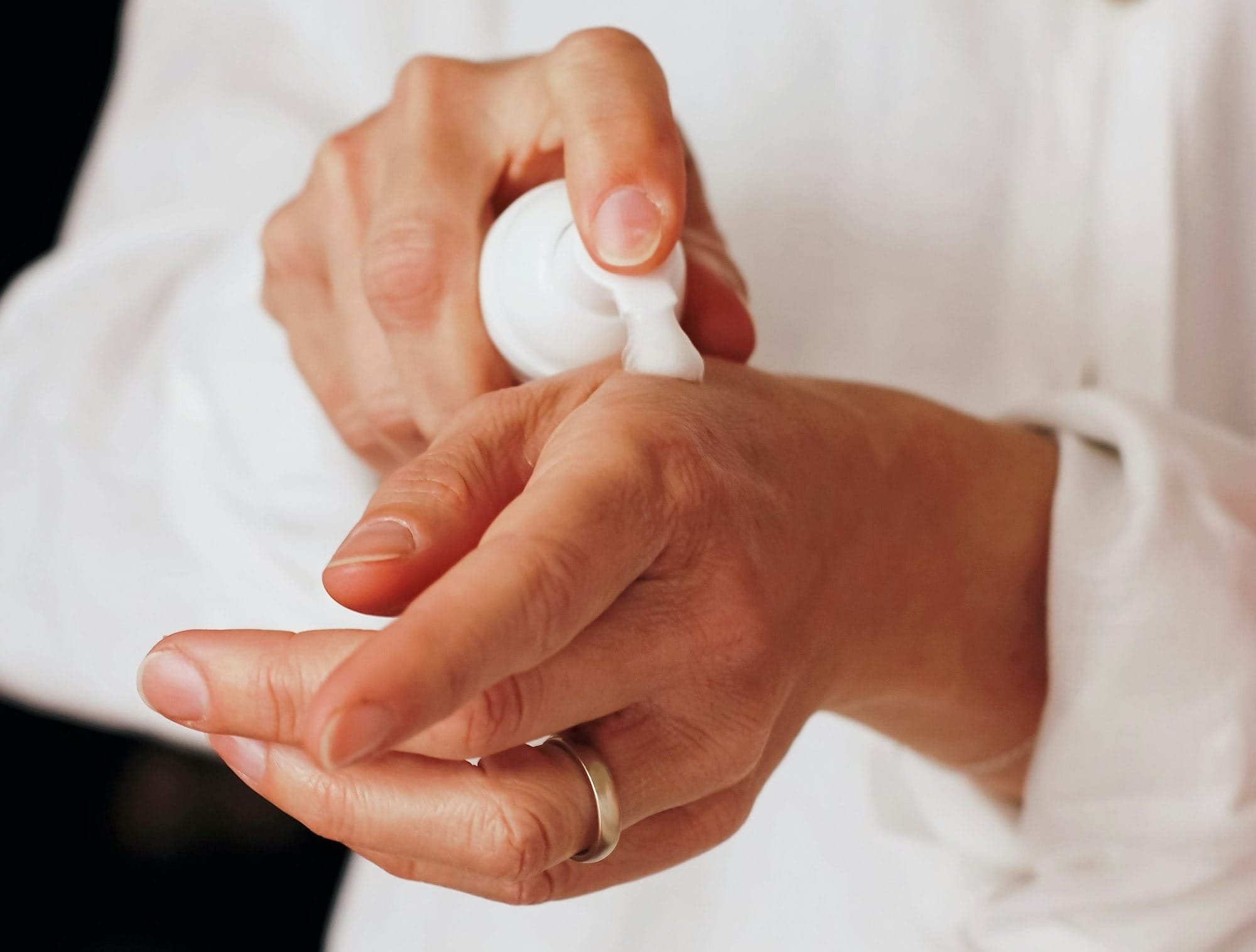 person holding white round ornament