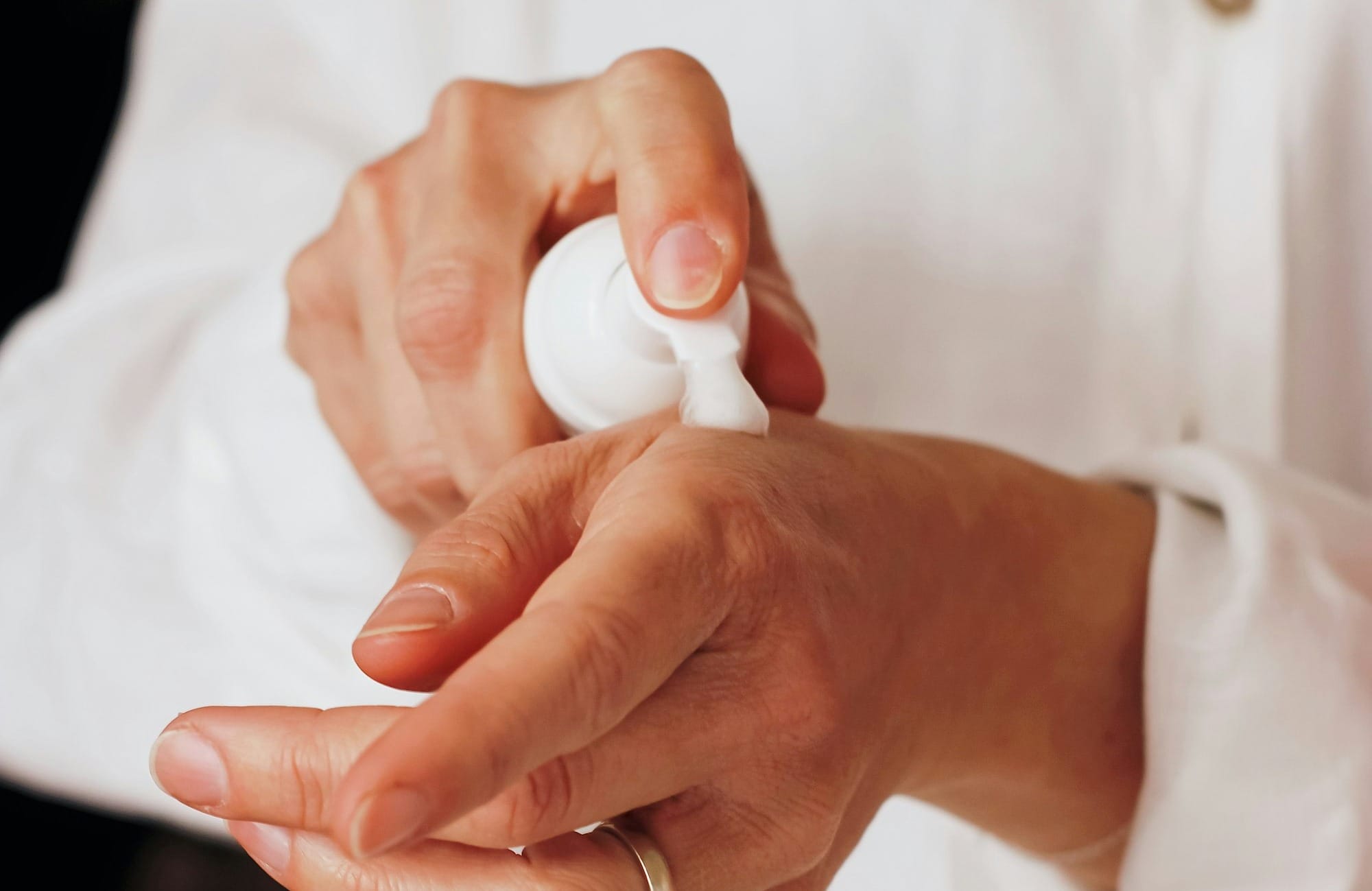 person holding white round ornament