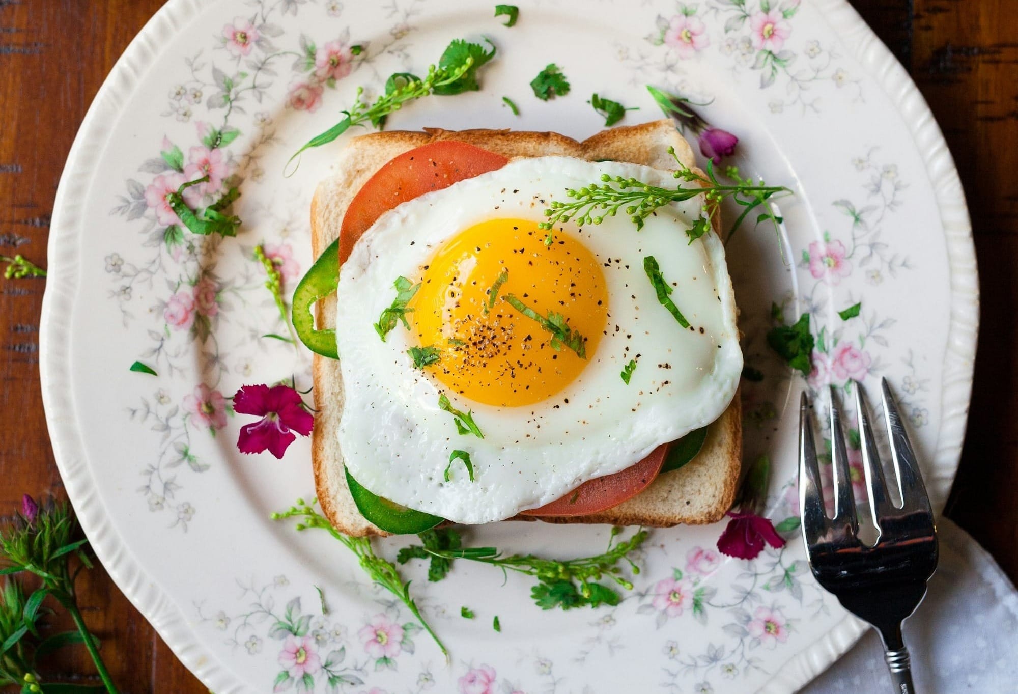 sunny-side up egg with bread beside fork