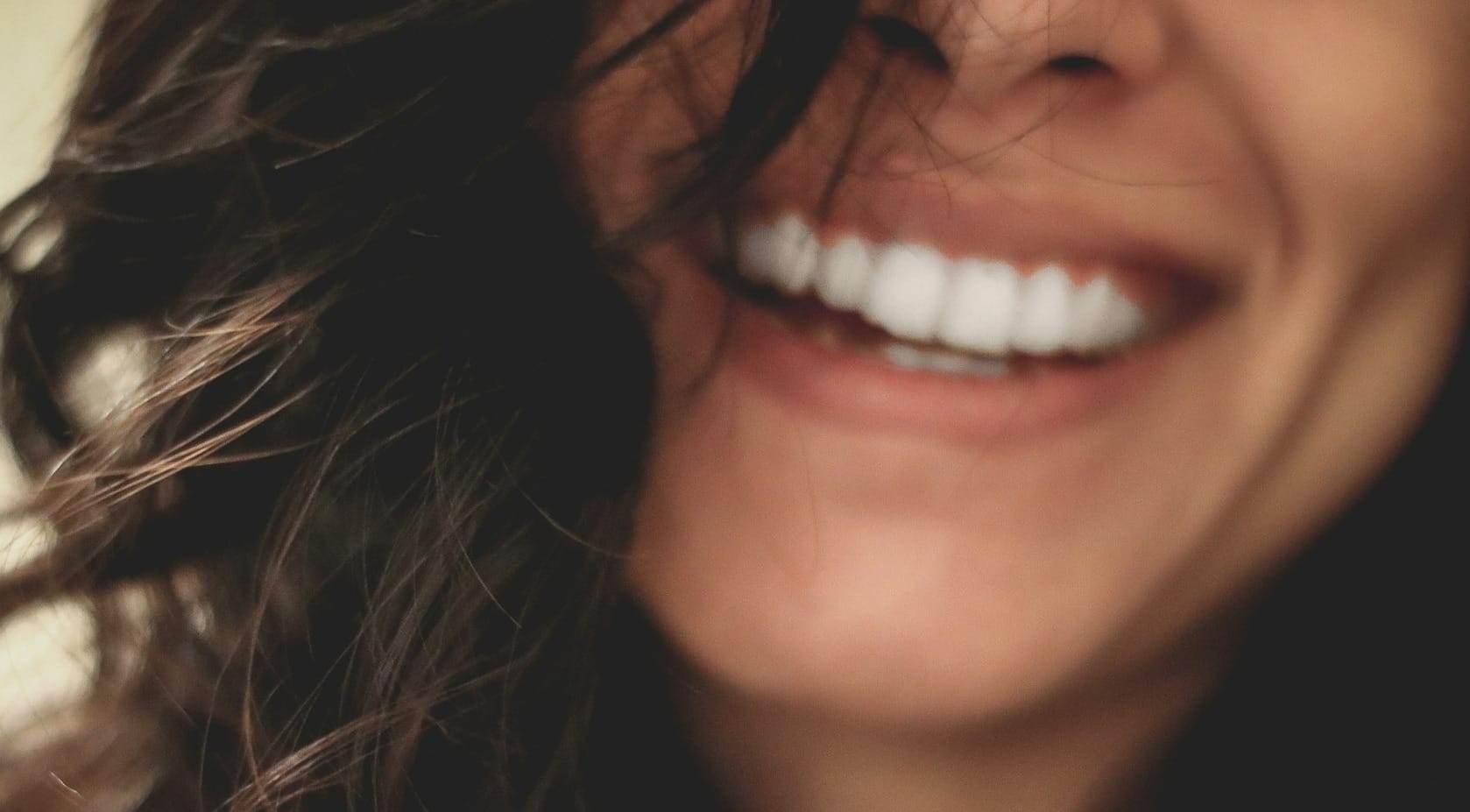 long black haired woman smiling close-up photography