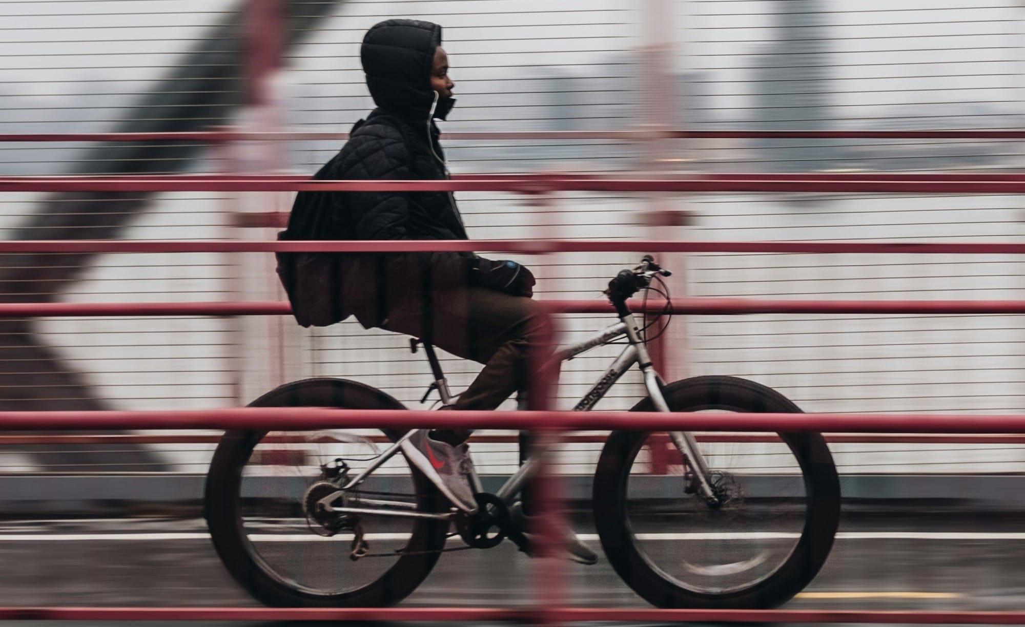 man riding bicycle on bridge