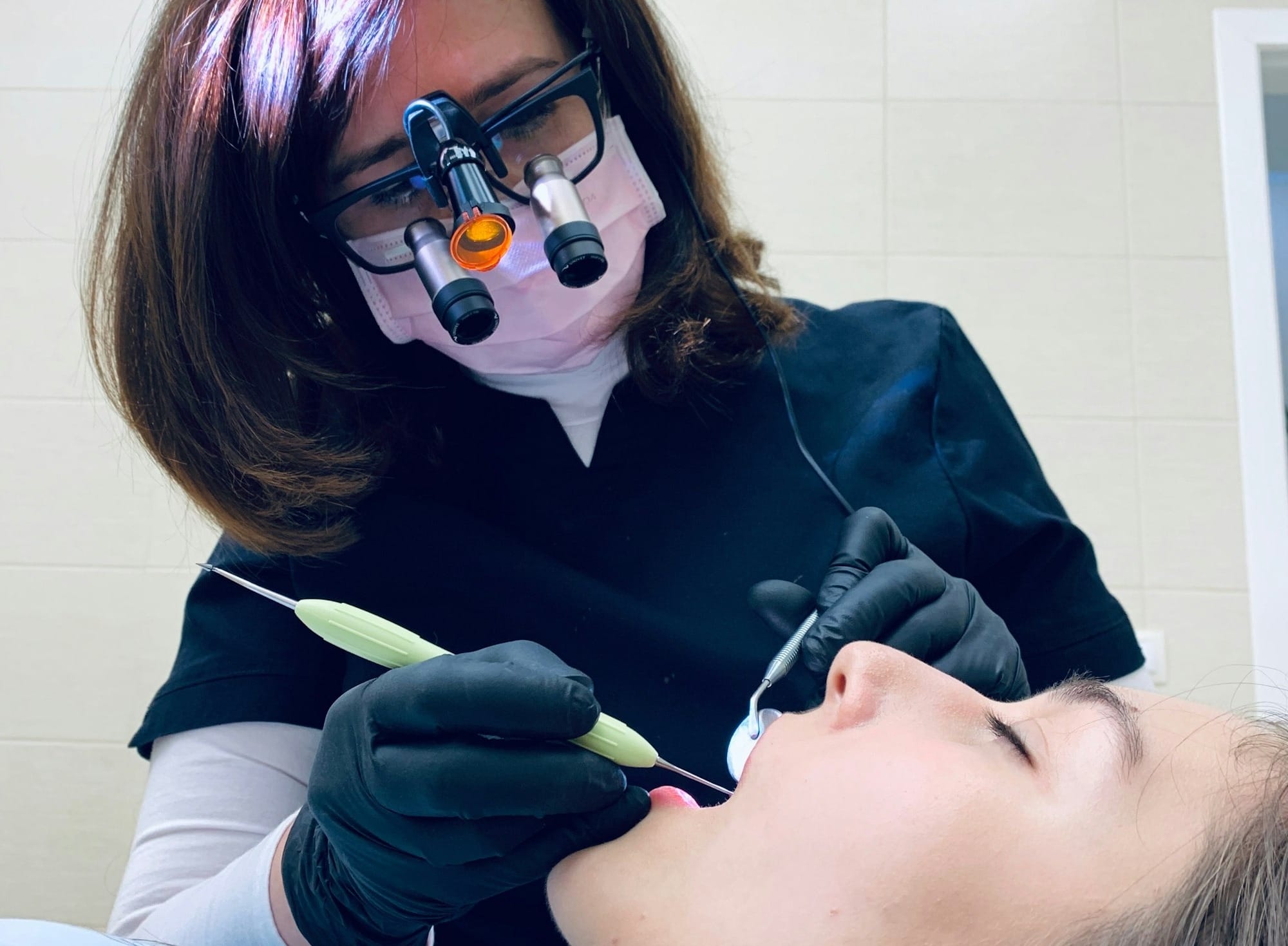 woman holding medical tool on person's mouth