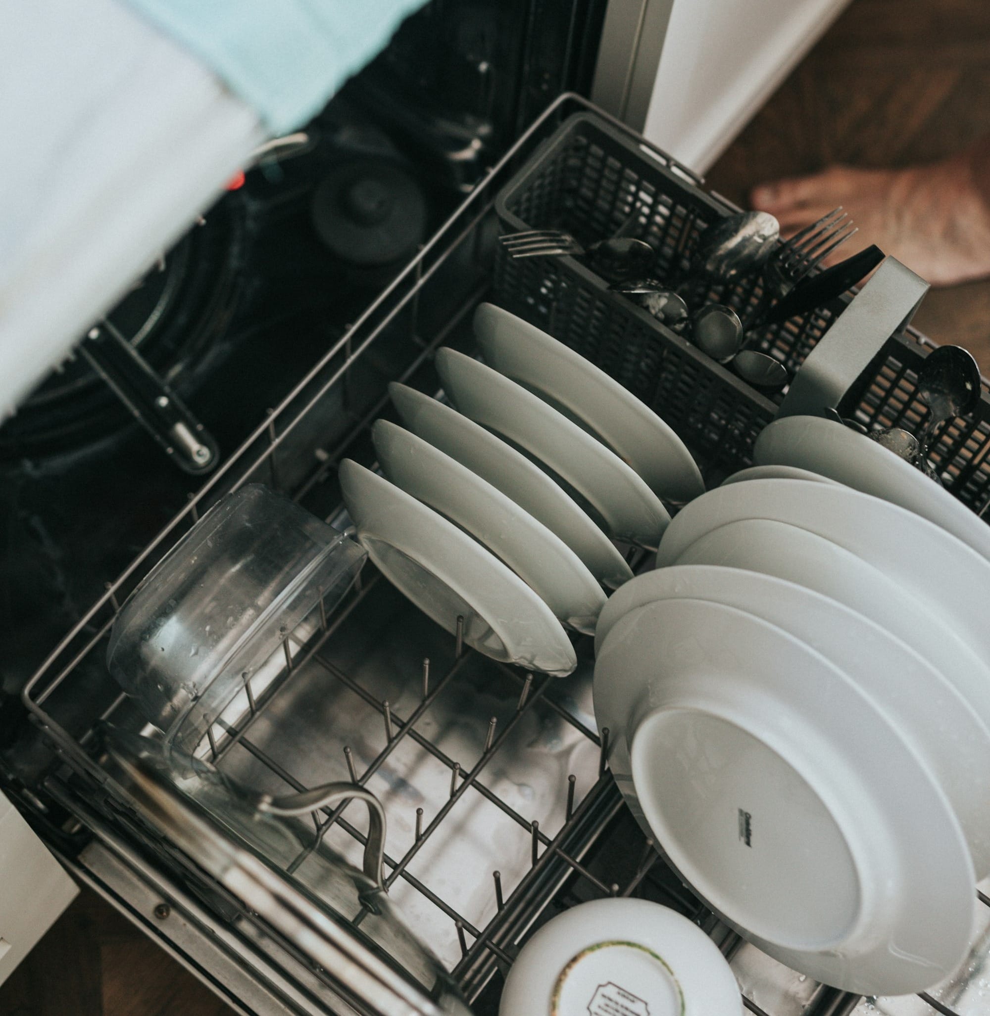 white ceramic plate on black dishwasher