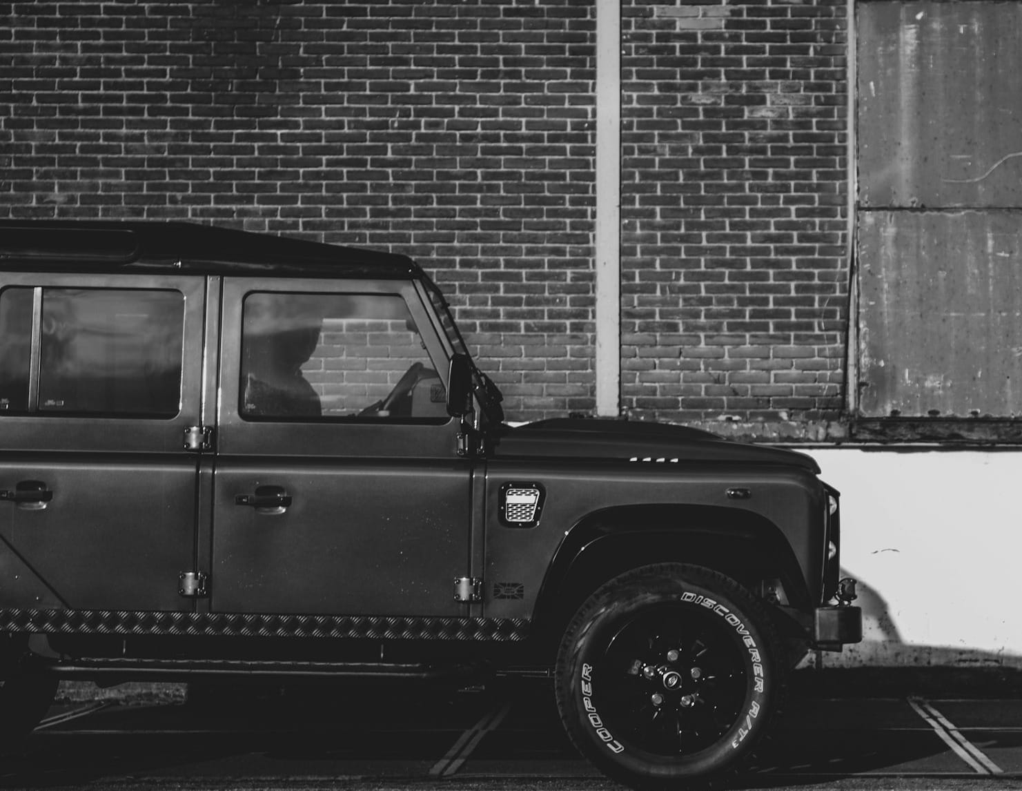 grayscale photo of car on road